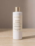 RootWellHair Barrier Restore Repair Conditioner bottle with label, creamy conditioner texture visible in a natural setting.